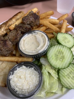 Steak and chicken kabobs with salad and fries. Great flavor and very tender proteins.