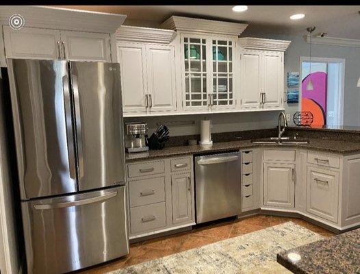 After: Off white paint color on upper cabinets with a medium grey color on the lower cabinets and new hardware