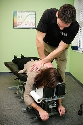 Dr. Sandez performing a Spinal Adjustment