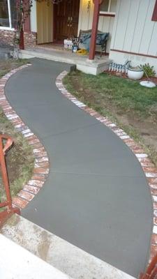 sidewalk with a brick band