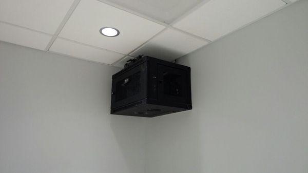 Wall mount holding Direct TV controllers and HDMI over Ethernet transmitters.