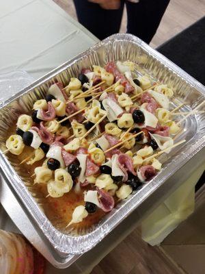 tortellini kabobs with 3 cheese tortellini,  black olives,  salami, provolone cheese and topped with zesty italian dressing.