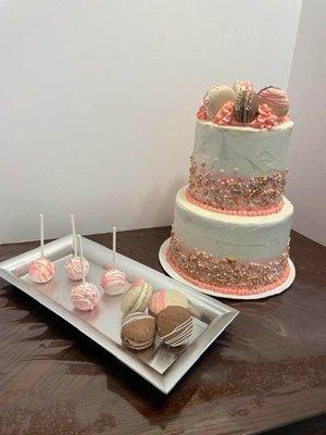 A cake for a sweet sixteen birthday with macarons and cake pops