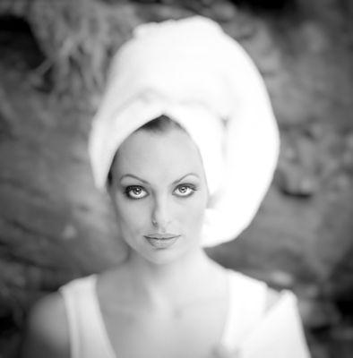 Beauty headshot of a bride gazing head-on with her hair wrapped in a towel.
 
 Photography by Phil Kramer.