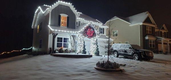 Bright White Christmas lights. Gingerbread style and stone pillar wrapped