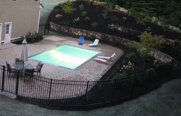 Fieldstone walls and steps; gunite pool; concrete coping and pavers; aluminum fence, landscape plantings