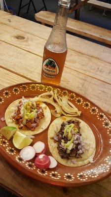 Pastor and barbacoa on soft corn taco, with the trimmings, and tamarind soda.