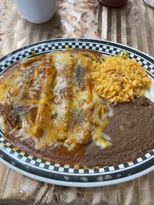 Cheese enchilada plater with Spanish rice and refried beans