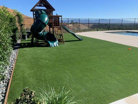 Artificial pet turf for yard with play set in Los Angeles.