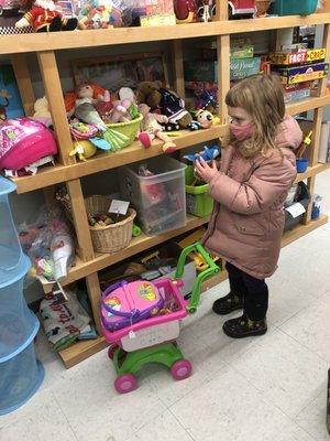 A young shopper inspects the toys.