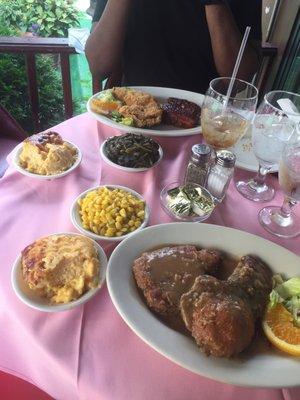 Smothered pork chop, Mac and cheese, corn, collard greens, and the country bbq special: fried chicken leg and bb ribs