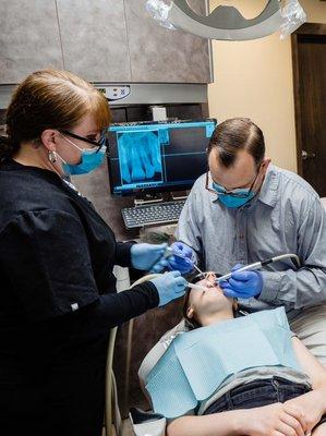 Dr. Thomas helping a patient with an dental treatment at our Mercer Island dental office.