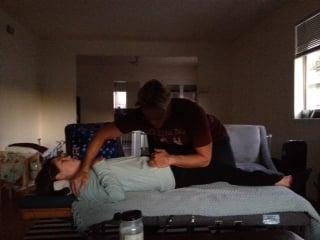 Dr. Scott adjusting my lower back in my living room. Such relief!