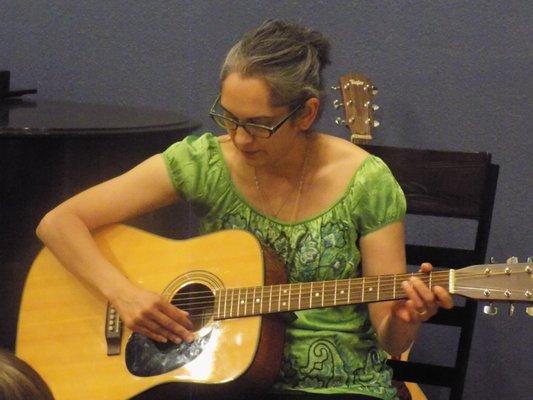 student recital performance on acoustic guitar