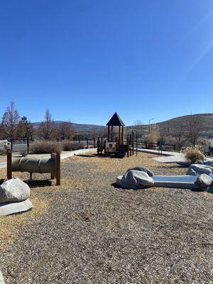 View of climbing tube and smaller playground.