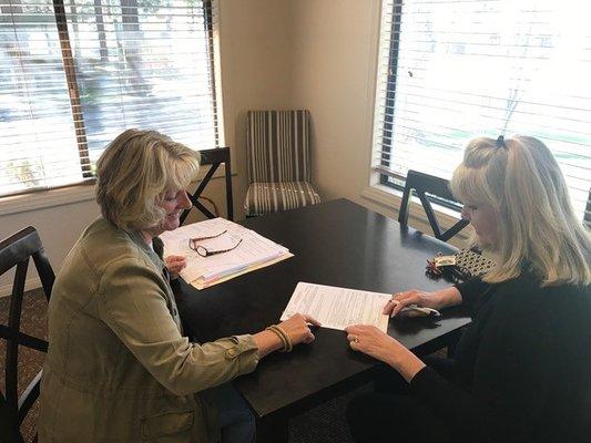 Judy signing escrow instructions with one of our clients!