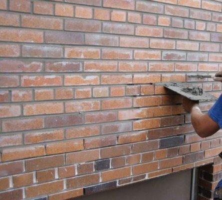 Brick work getting new mortar and repointing to a smooth surface.