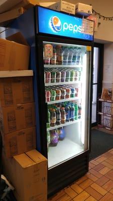 Soda cooler just inside the front door.  Note the cardboard boxes in the dining room...