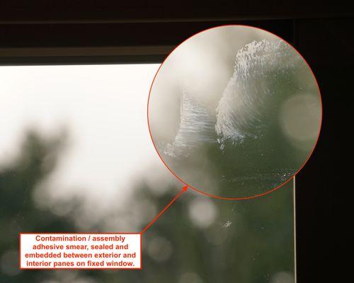 Smears between exterior and interior panes on fixed window.