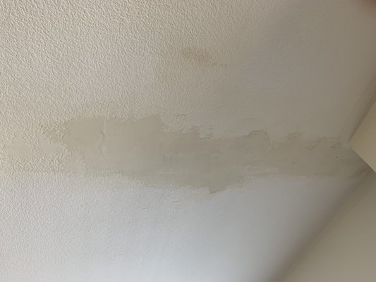 Prior water leak in living room. Instead of opening ceiling they put spackle over it