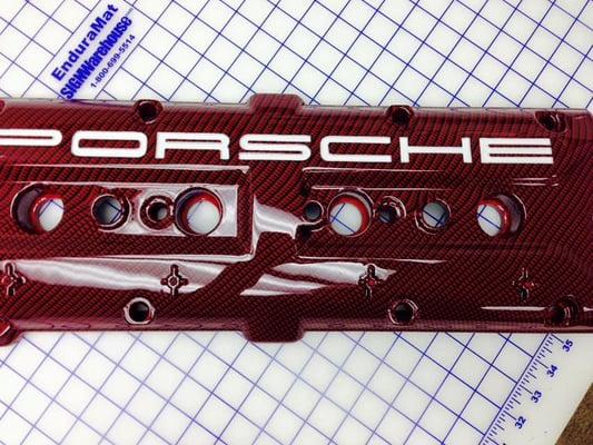 Valve cover done in carbon fiber over red.