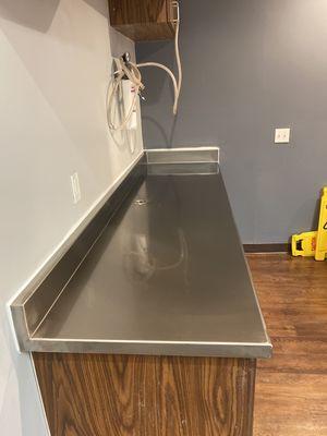 Stainless steel counter top for ice maker. Custom grommet for water lines