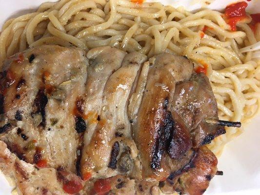 Lemongrass chicken skewer over mushy garlic noodles