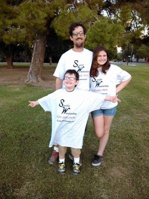 Sean Scanlan (owner) and family wearing company shirts.