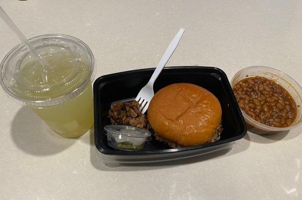 Brisket Sandwich Combo - paired with baked beans and pineapple lemonade.