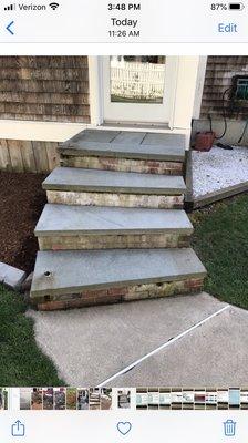 Back steps, bricks are crumbling and stained from mortar washing away over the years.