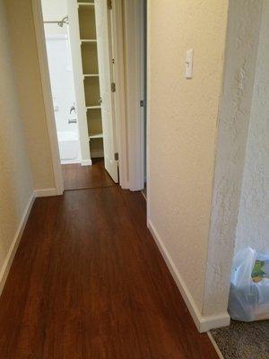 Looking down hallway of 1bed/1ba into bathroom. Bedroom and living room on right side