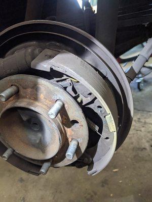 Brake shoe that has uneven wear and must be replaced in order to restore safe and proper braking performance.