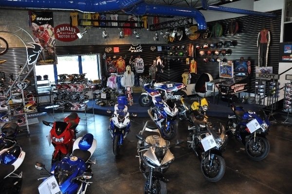 One side of the shop with New Yamaha and the 60s.70s wall of motorcycle memorabilia