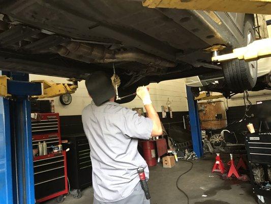 One of the mechanics working on a car.