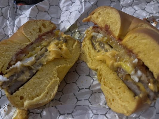 Sausage egg cheese with hash brown on egg bagel