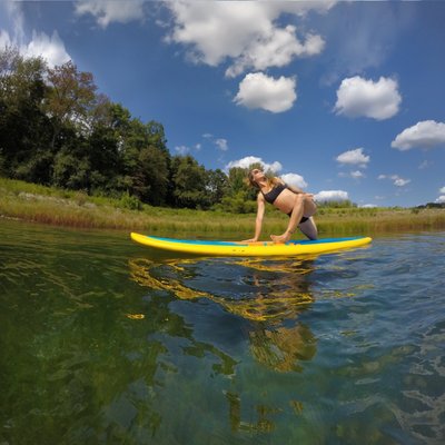 Miss Melanie demoing yoga on her board.