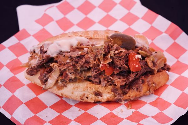 Cheesesteak with onions, peppers and hot peppers.