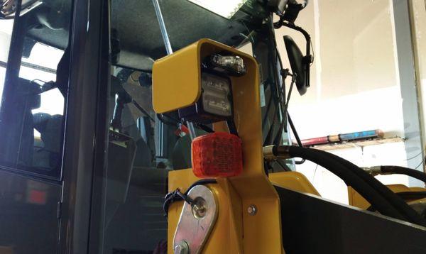 Unique placement of a Whelen ION 'V' Series on a JD624 wheel loader. Above the left and right headlight.