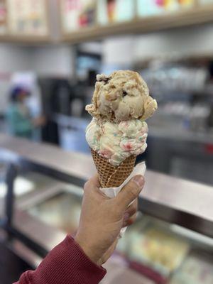 2 scoop cone with Peppermint ice cream (bottom) and peanut butter cup (top)