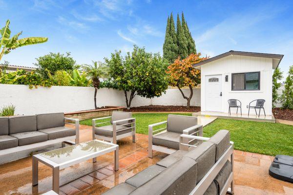 The back patio, lounging area and yard