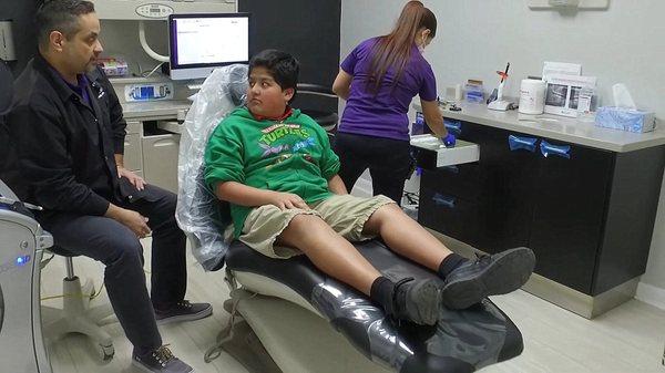 Laredo dentist explaining root canal therapy to patient at Ahh Smile Family Dentistry