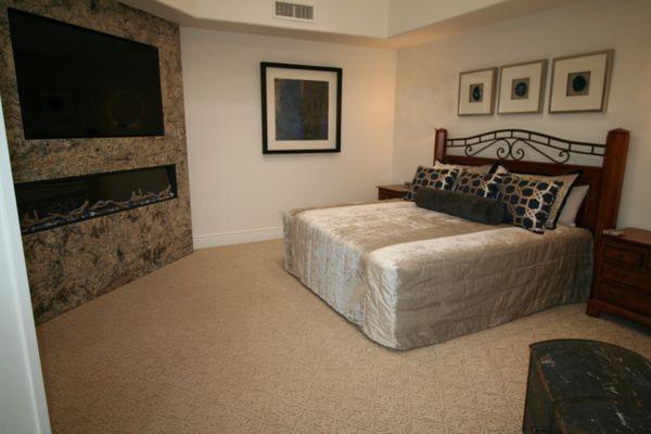 Gold Canyon. Beautiful luxurious custom bedding and a showstopper Azurite Quartzite fireplace wall.