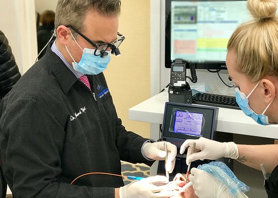 Dr. RIchard Nejat performing LANAP treatment on a patient to help treat severe gum disease.