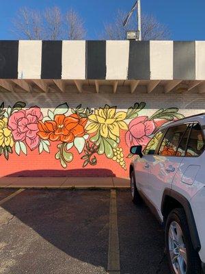 Hard to miss from the road, Whimsical Wit storefront is so cute with the floral mural & black and white striped awning!