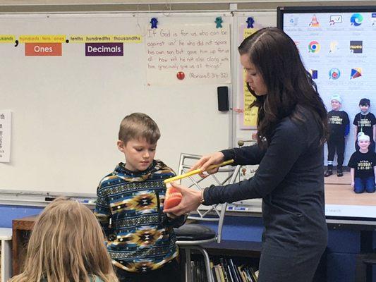 Hygienist Christi and her son Frankie pictured at a workshop at Southwest Chicago Christian School teaching 2nd graders about oral hygiene.