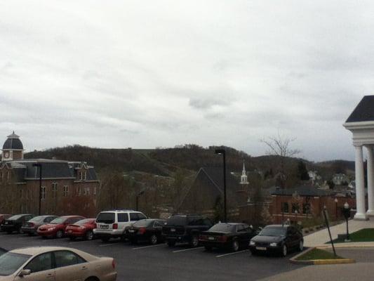 As you walk behind the campus chapel, you will eventually reach the cemetery, which is the highest point in town. Good views.