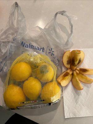 Moldy produce, a lemon bag and apple, with a Walmart bag.