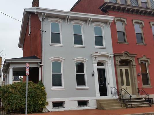 This two story brick home looks completely different after a color change for both the brick and trimwork.