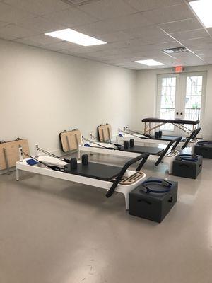 Pilates Reformers set up for class at our new location by the St. Simons Island Pier.