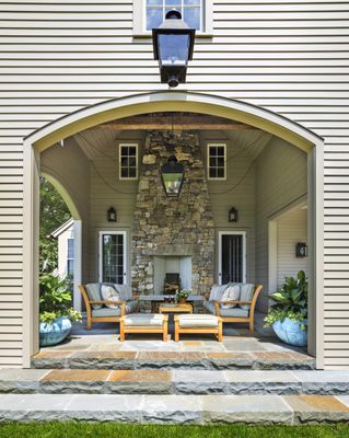 Porch with fireplace and lounge seating